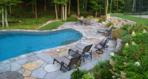 A backyard patio and pool created by Freddy & Co.